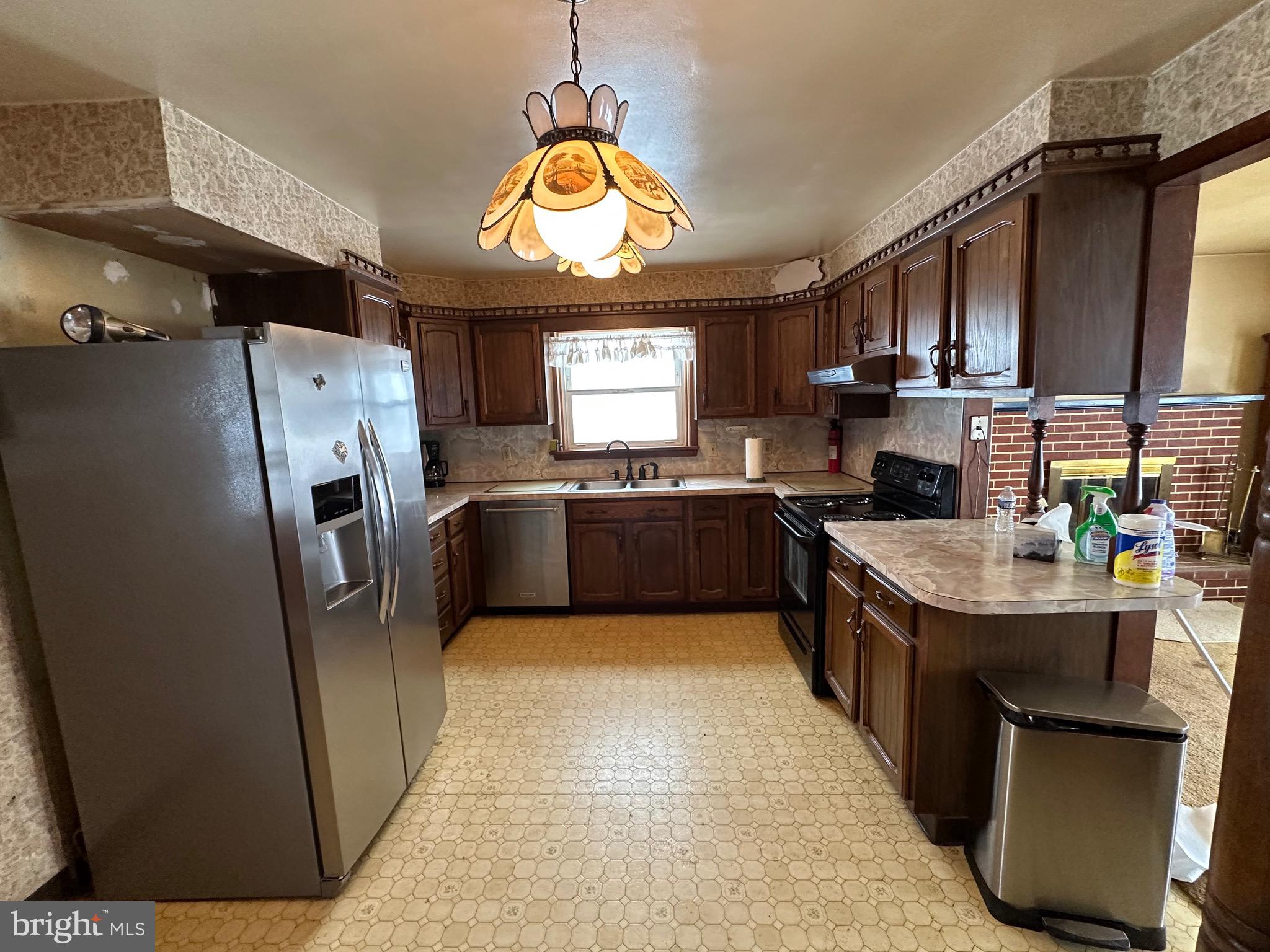 412 Grandview Avenue Perkasie, PA 18944 - Photo 5 of 11 a kitchen with stainless steel appliances granite countertop a sink a stove a refrigerator cabinets and a window