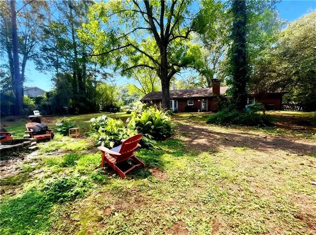 a backyard of a house with table and chairs