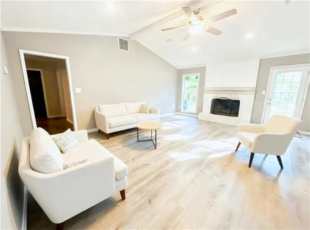 a living room with furniture and a fireplace