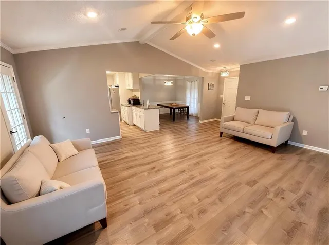 a living room with furniture and wooden floor
