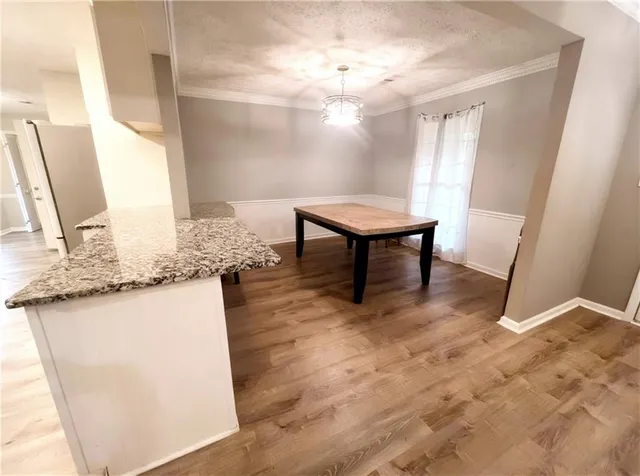 a view of kitchen with furniture and wooden floor