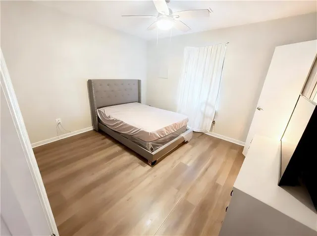 a room with a bed and a flat screen tv