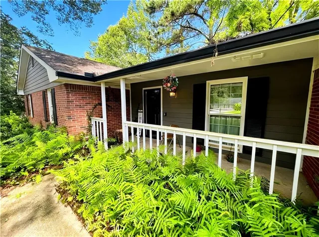 a view of a house with a flower garden