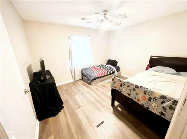 a bedroom with a bed and a chair