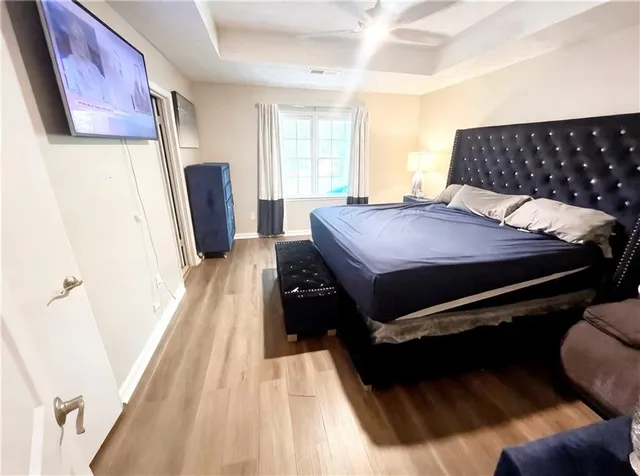 a bedroom with a bed and wooden floor