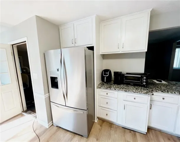 a white refrigerator freezer sitting inside of a kitchen