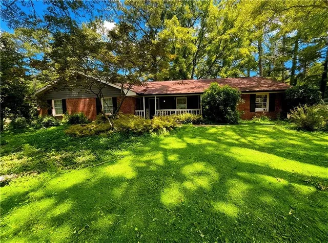 a front view of house with yard and green space