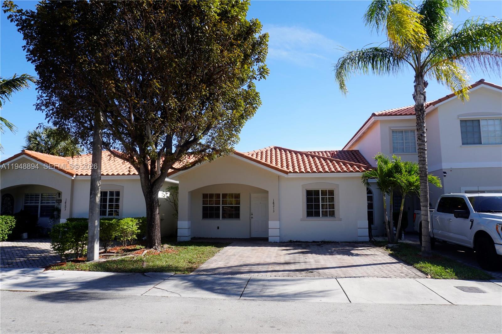a front view of a house with a garden