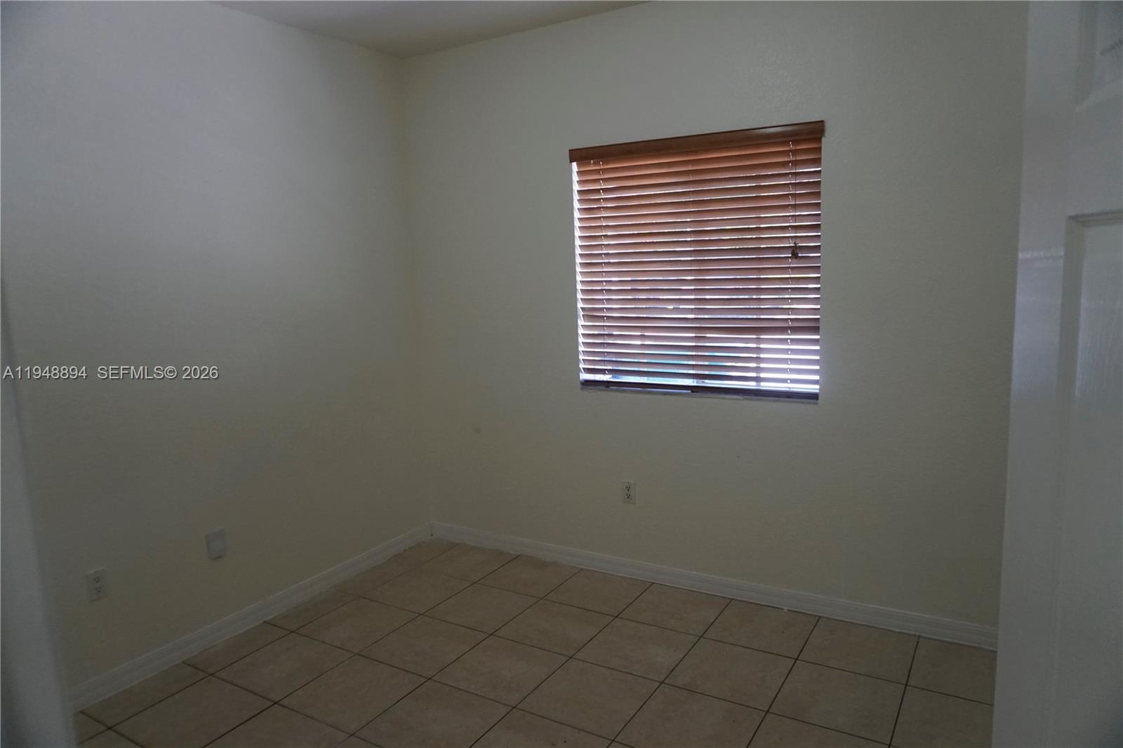 18213 Southwest 109th Path Miami, FL 33157 - Photo 11 of 26 a view of an empty room with a window