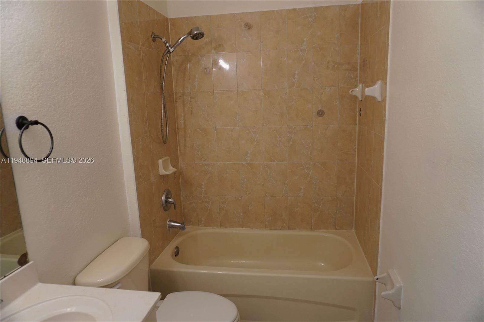 18213 Southwest 109th Path Miami, FL 33157 - Photo 13 of 26 a bathroom with a granite countertop bathtub shower and a toilet