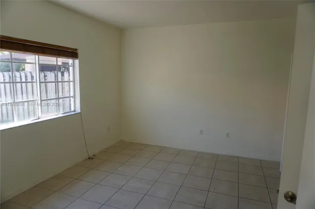 an empty room with a empty space and window