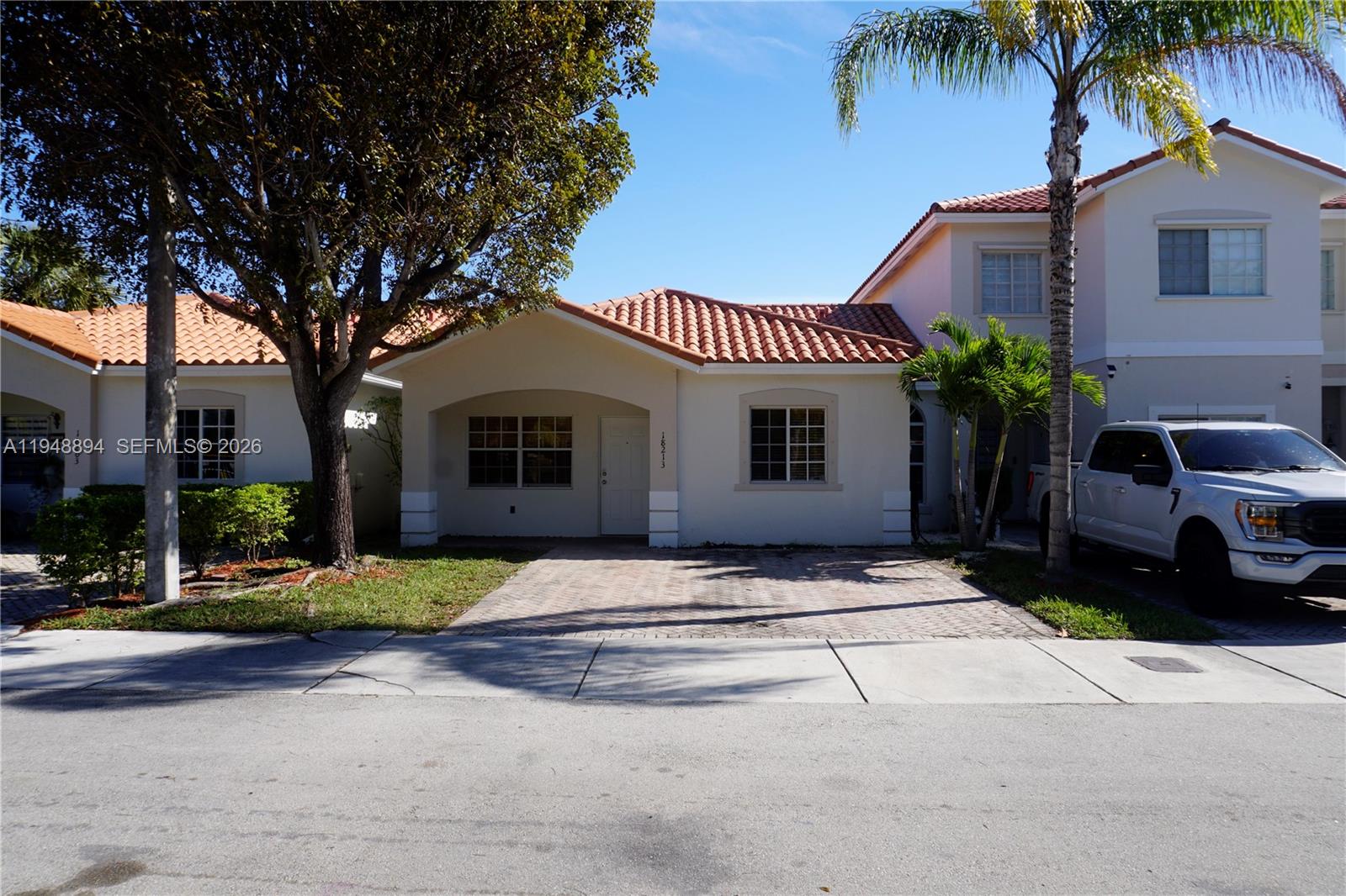 18213 Southwest 109th Path Miami, FL 33157 - Photo 2 of 26 a front view of a house with a yard and garage