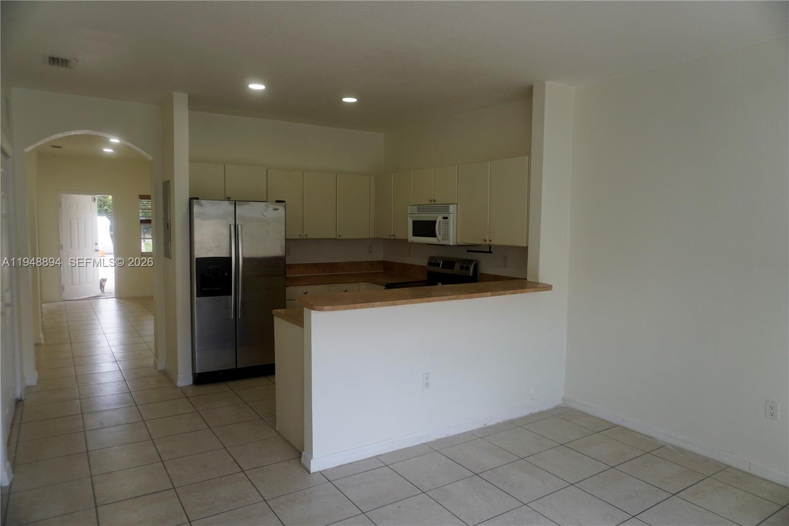 18213 Southwest 109th Path Miami, FL 33157 - Photo 3 of 26 a kitchen with a refrigerator and a counter top
