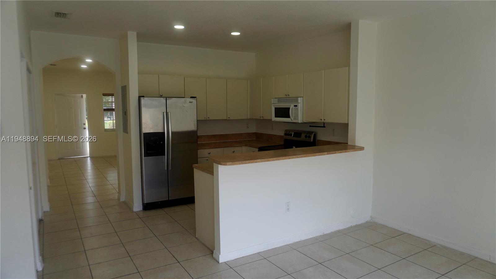 18213 Southwest 109th Path Miami, FL 33157 - Photo 4 of 26 a kitchen with stainless steel appliances a refrigerator and a stove