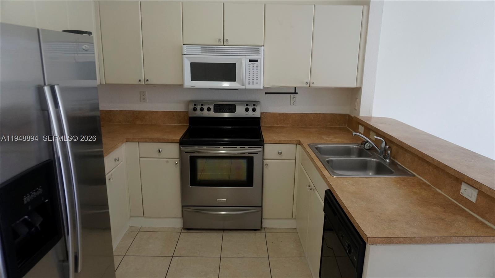 18213 Southwest 109th Path Miami, FL 33157 - Photo 5 of 26 a kitchen with a stove microwave and refrigerator