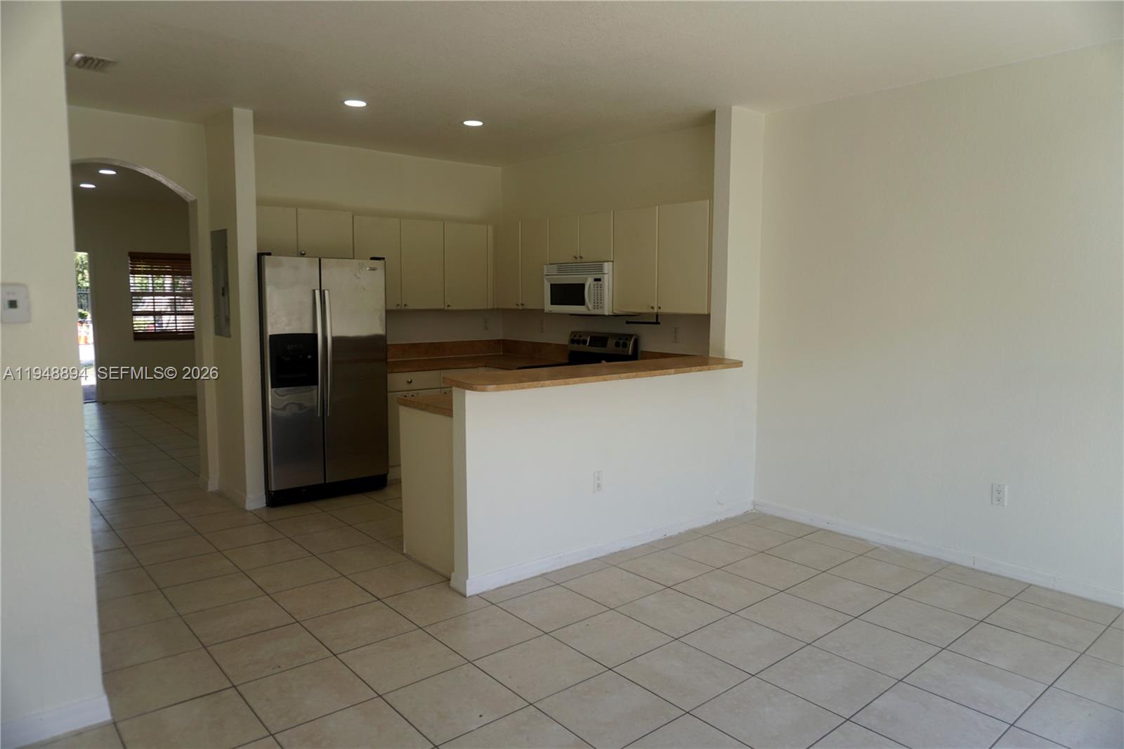 18213 Southwest 109th Path Miami, FL 33157 - Photo 7 of 26 a kitchen with a sink a refrigerator and cabinets