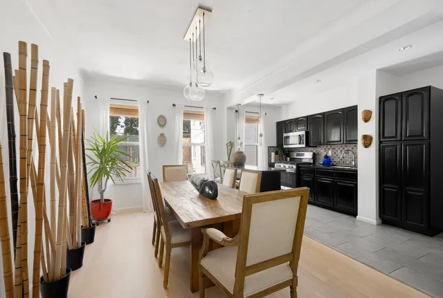 a kitchen with a table chairs refrigerator and microwave