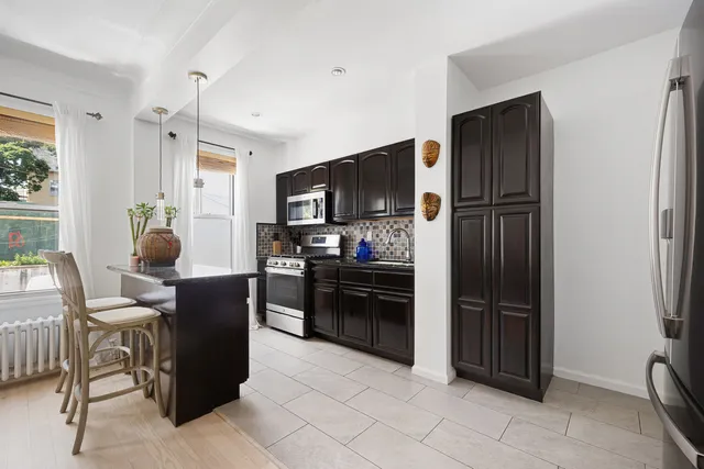 a kitchen with a refrigerator and furniture