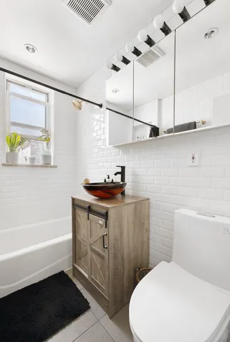 a bathroom with a sink a toilet and bathtub
