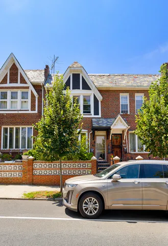 a front view of a house with parking space