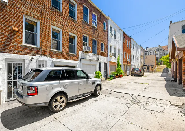 a front view of a house with parking space