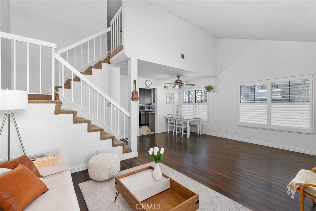 12700 Fallbrook Way Stanton, CA 92841 - Photo 6 of 31 a living room with couches and kitchen view with wooden floor