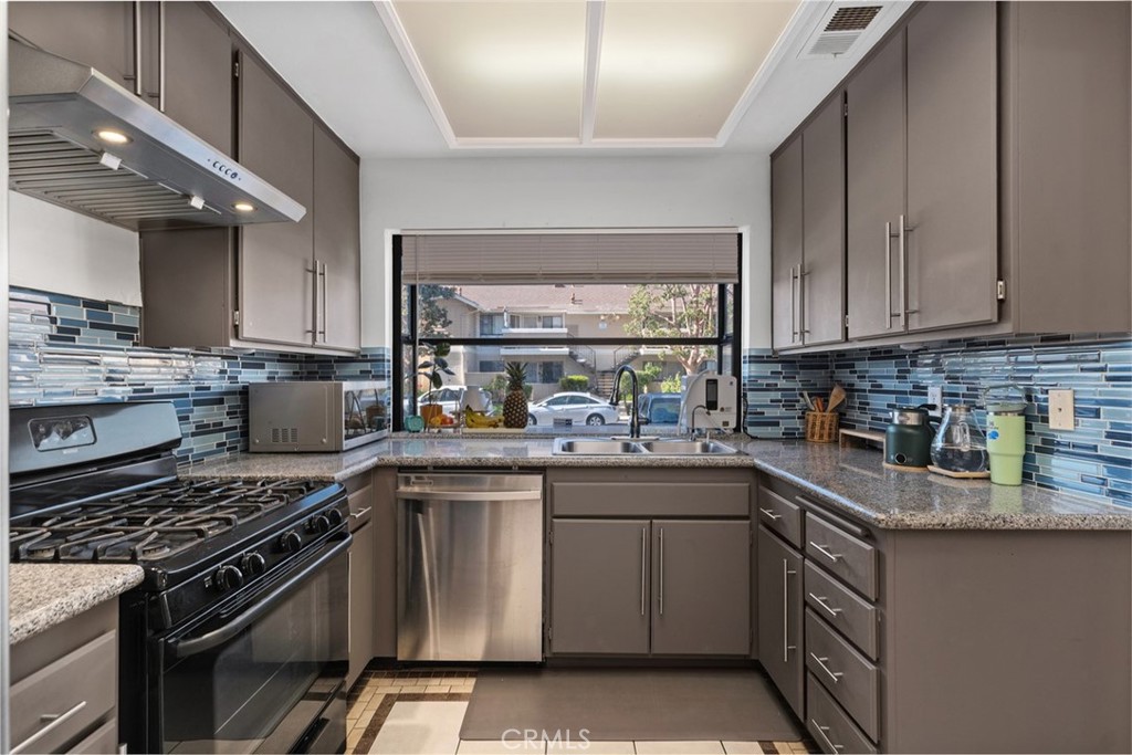 12700 Fallbrook Way Stanton, CA 92841 - Photo 10 of 31 a kitchen with a stove and a sink