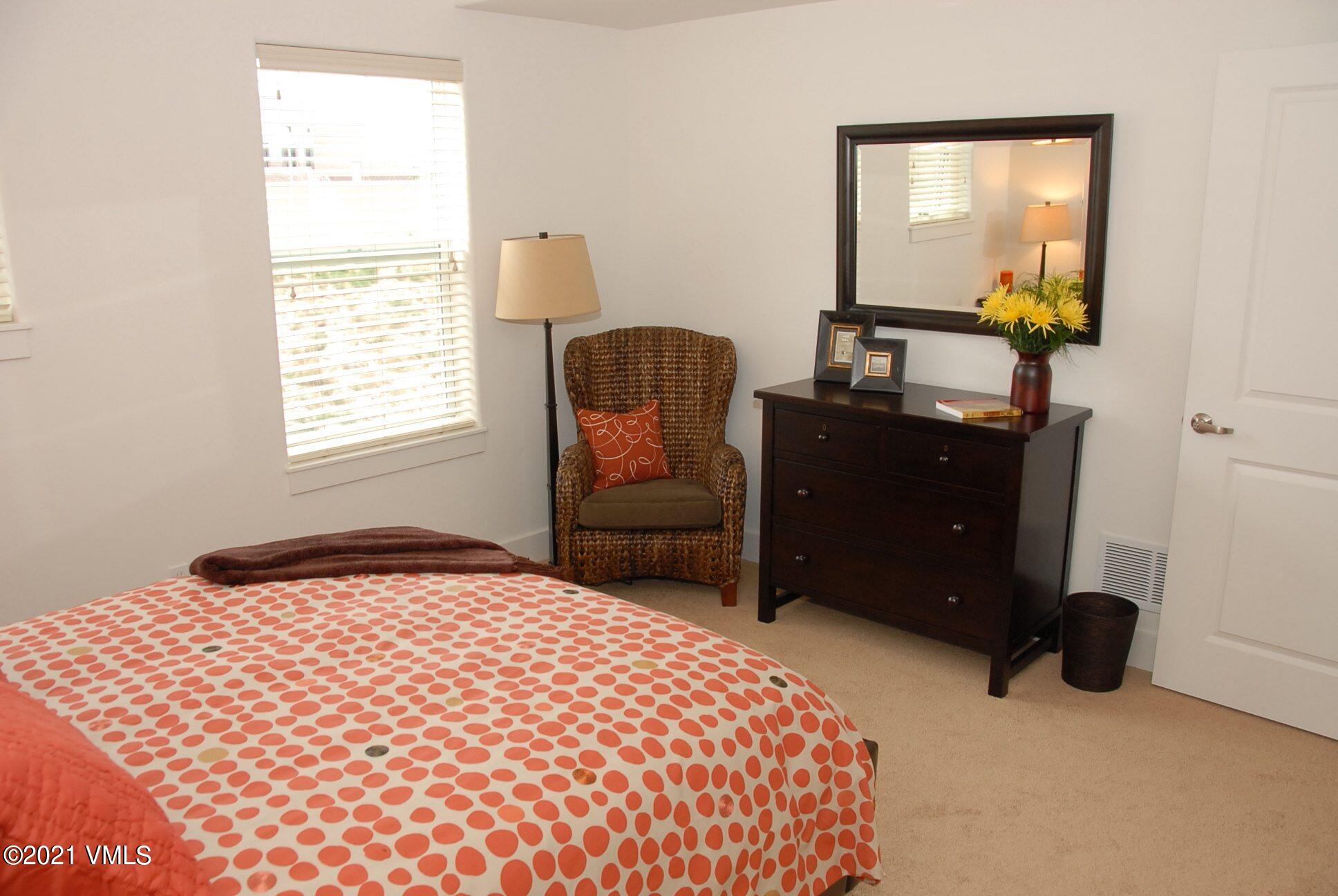 80 Freestone Road, Unit C101 Eagle, CO 81631 - Photo 11 of 14 a bedroom with a bed and a dresser