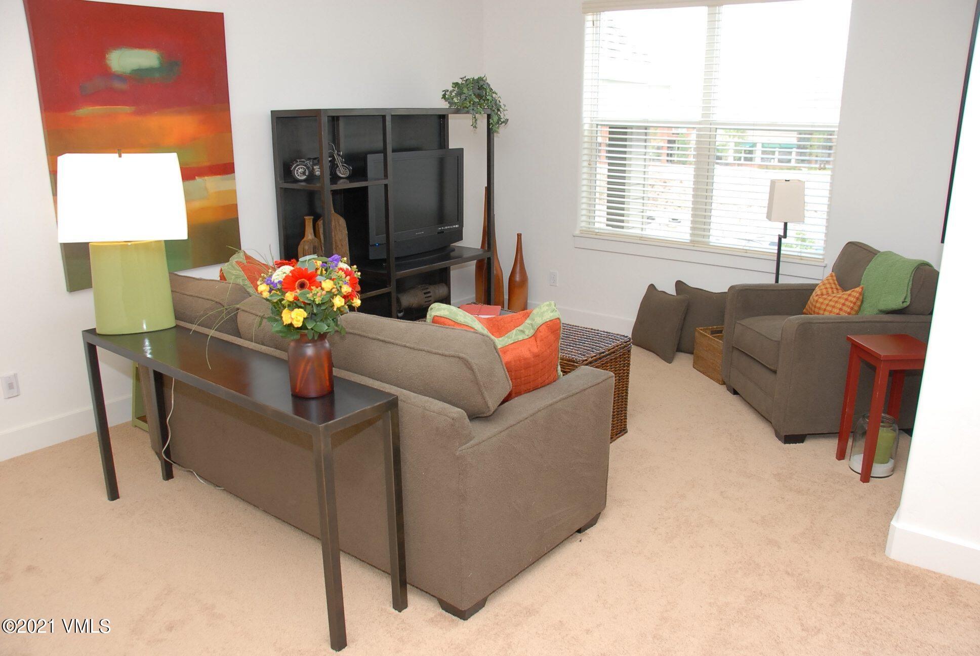 80 Freestone Road, Unit C101 Eagle, CO 81631 - Photo 3 of 14 a living room with furniture and a large window