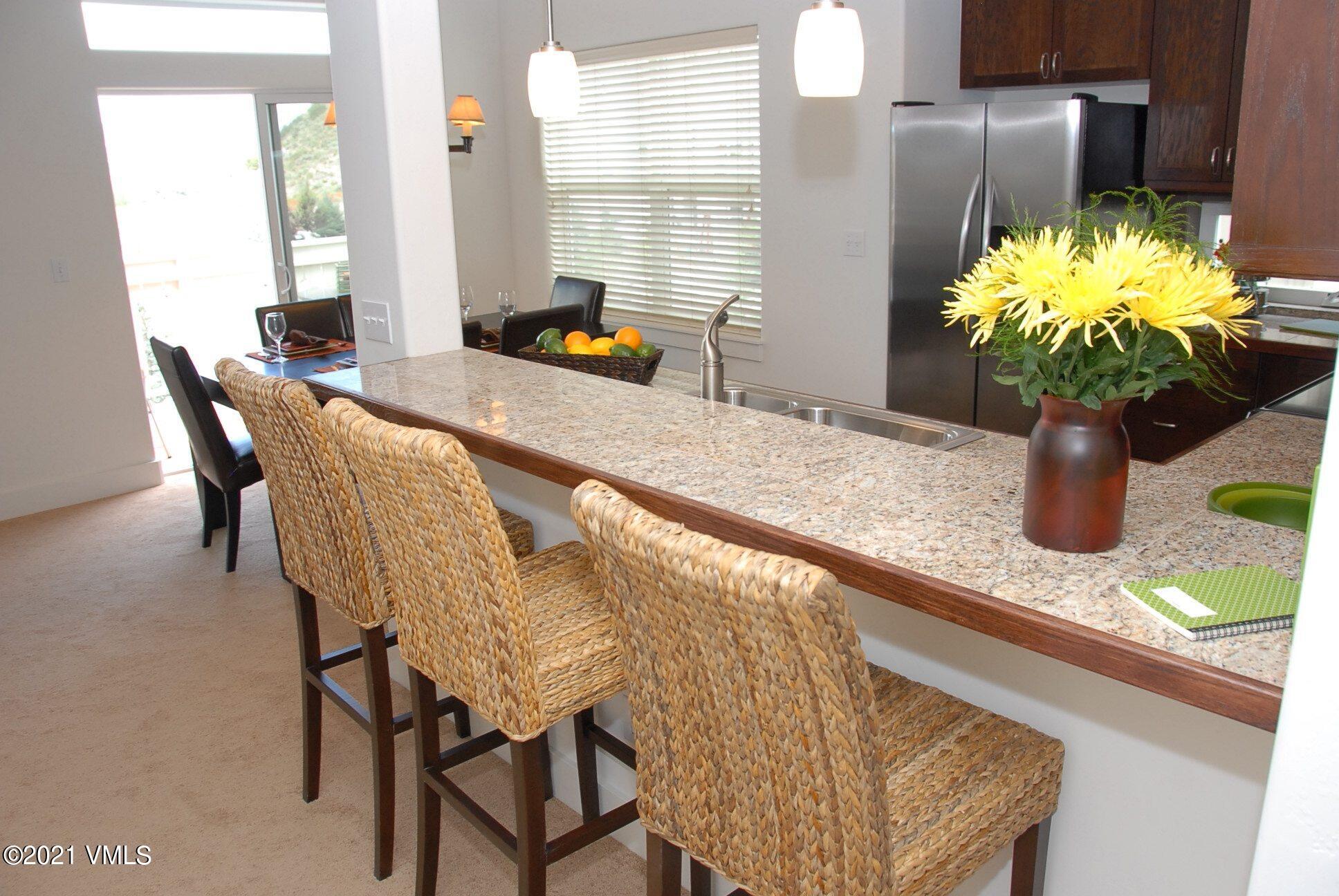 80 Freestone Road, Unit C101 Eagle, CO 81631 - Photo 9 of 14 a view of a dining room with furniture and a potted plant