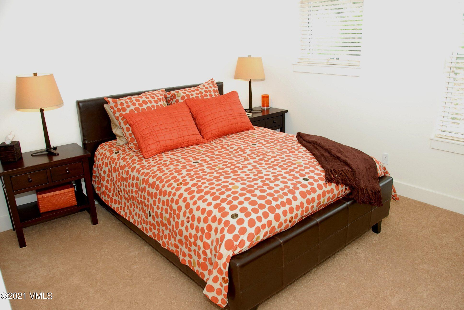 80 Freestone Road, Unit C101 Eagle, CO 81631 - Photo 10 of 14 a bed sitting in a bedroom next to a lamp