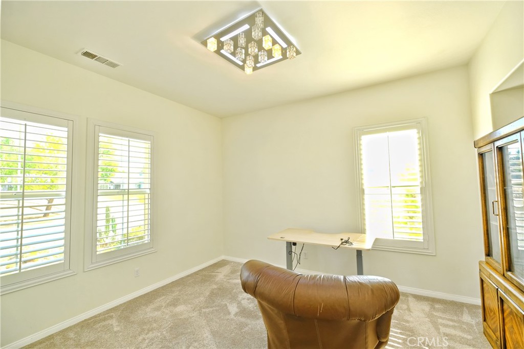 1791 Hannon Road Cherry Valley, CA 92223 - Photo 11 of 41 a bedroom with a couch and a window