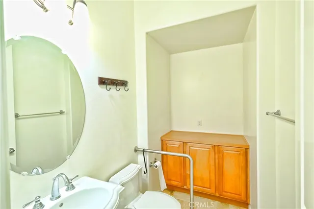 a large kitchen with stainless steel appliances a large counter top a stove and a refrigerator