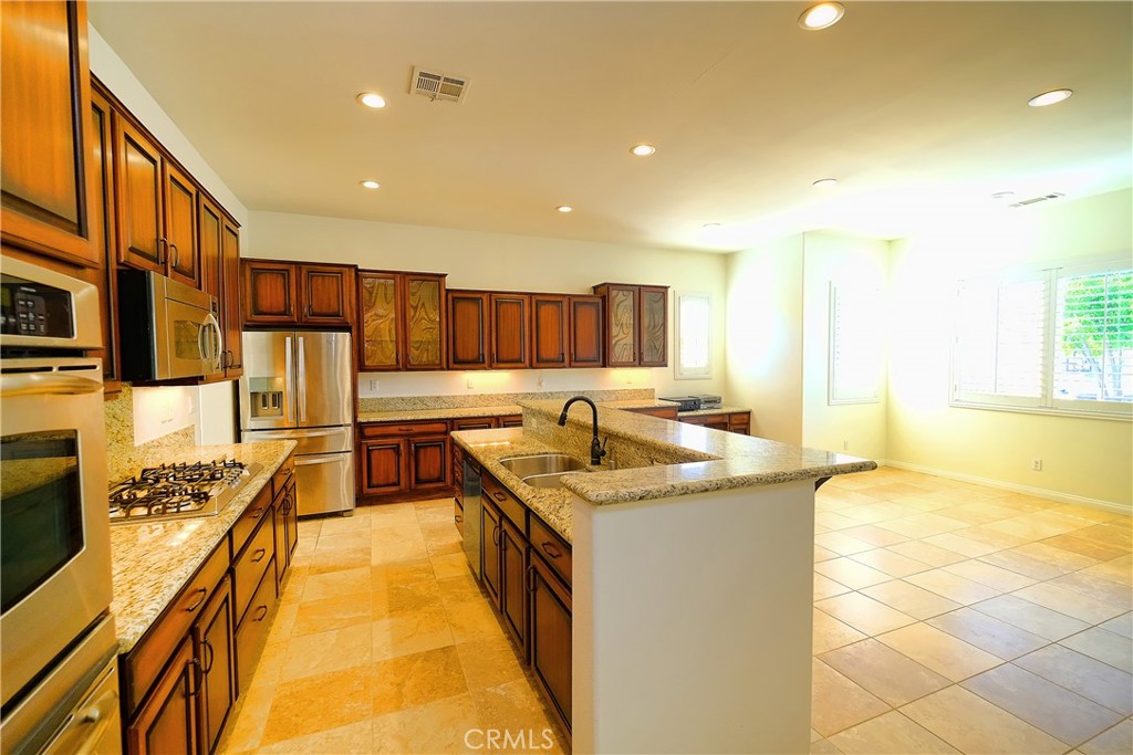 1791 Hannon Road Cherry Valley, CA 92223 - Photo 13 of 41 a kitchen with stainless steel appliances granite countertop a sink and cabinets
