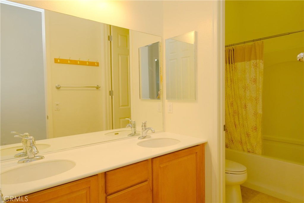 1791 Hannon Road Cherry Valley, CA 92223 - Photo 27 of 41 a bathroom with a granite countertop sink and a mirror