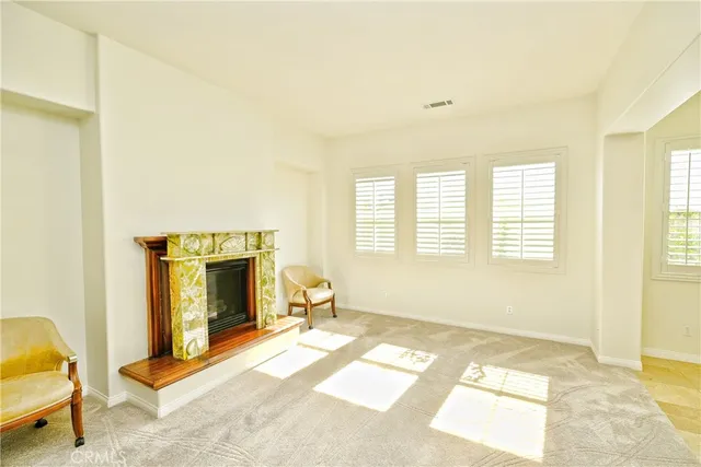 a view of a dining room with furniture and a fireplace