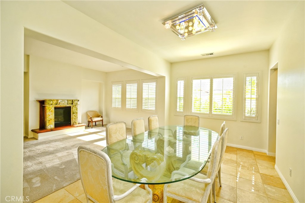 1791 Hannon Road Cherry Valley, CA 92223 - Photo 9 of 41 a view of a dining room with furniture and a fireplace