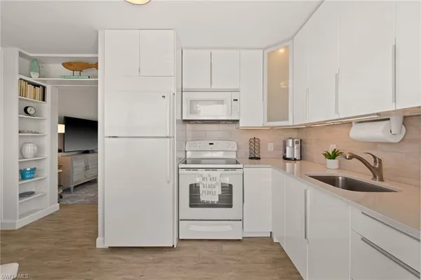 a kitchen with stainless steel appliances granite countertop a sink and a stove