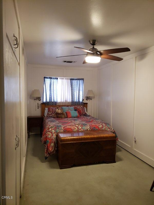 339 South Reed Avenue Reedley, CA 93654 - Photo 6 of 16 a bed sitting in a bedroom next to a window