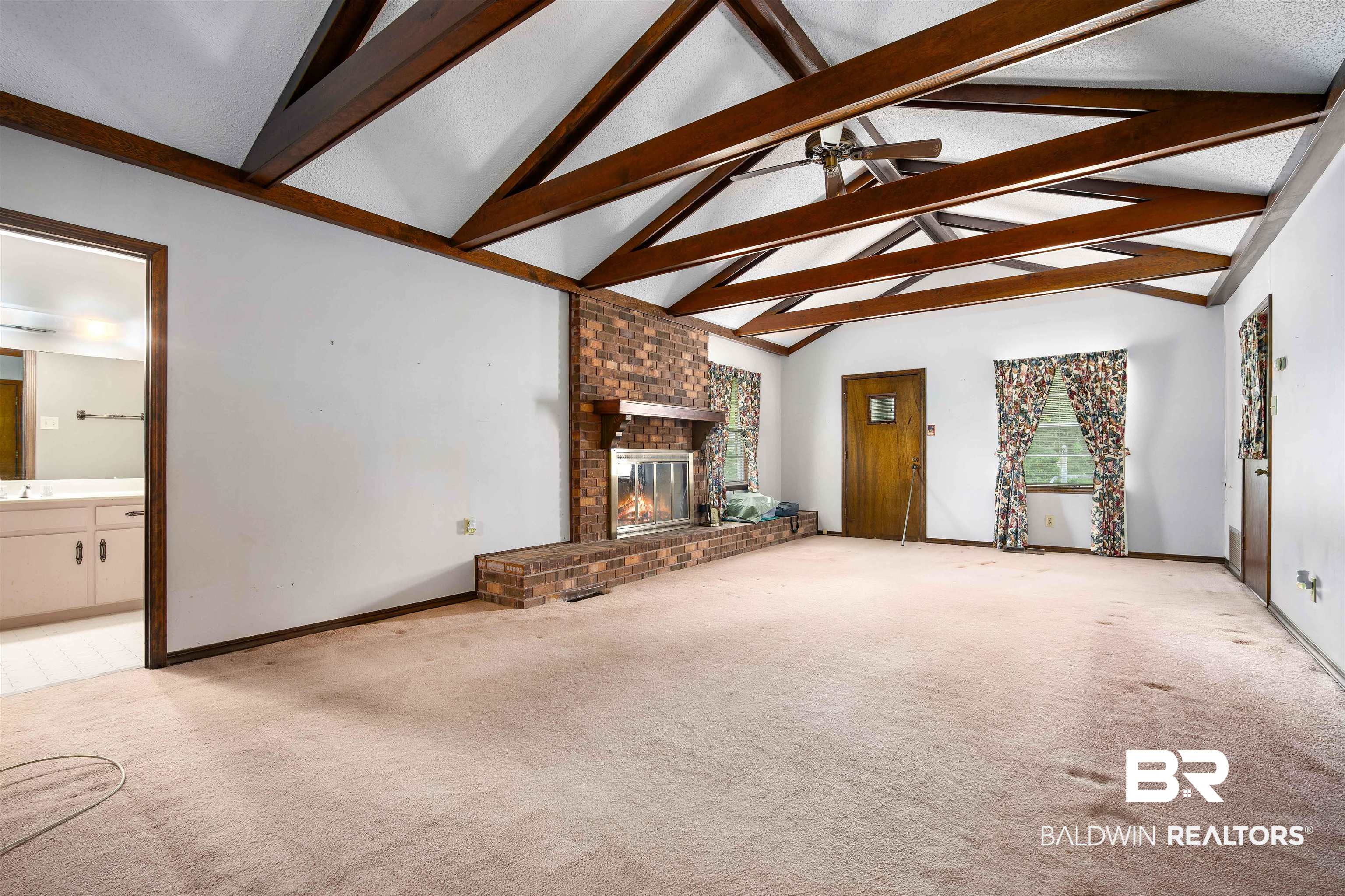2300 Ellen Drive Mobile, AL 36605 - Photo 5 of 25 Unfurnished living room featuring light colored carpet, ceiling fan, and a fireplace