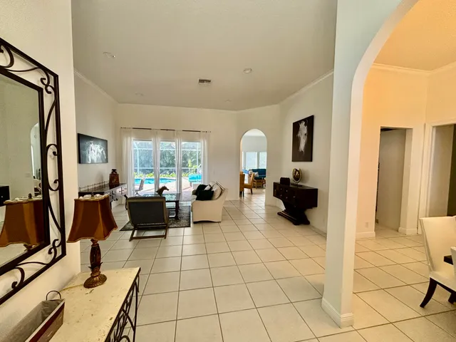 a living room with furniture and large windows