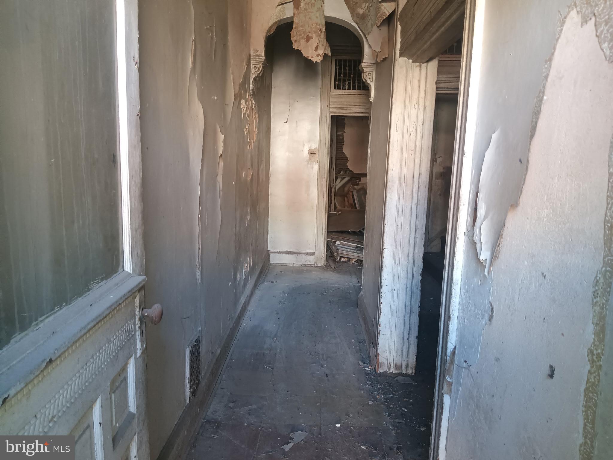 2605 East Preston Street Baltimore, MD 21213 - Photo 3 of 9 a view of a hallway with a wooden door