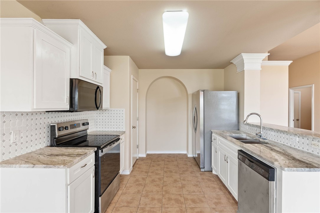 6606 Riding Wind Drive Corpus Christi, TX 78414 - Photo 4 of 15 a kitchen with stainless steel appliances granite countertop a sink stove and refrigerator