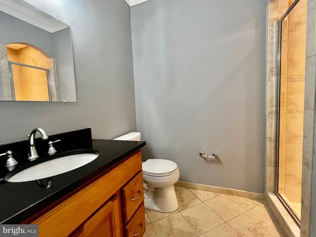 a bathroom with a sink a toilet and a window