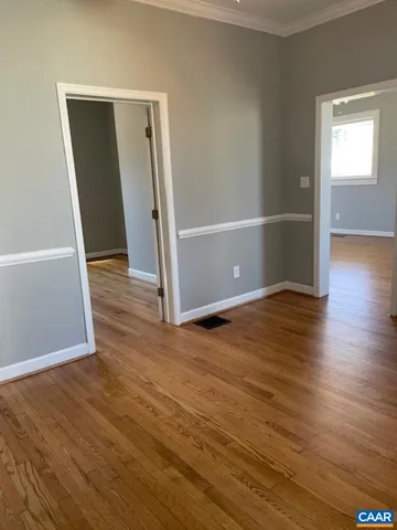 an empty room with wooden floor and closet