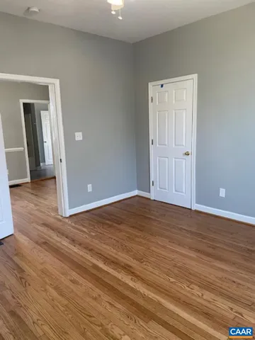 a view of an empty room and wooden floor