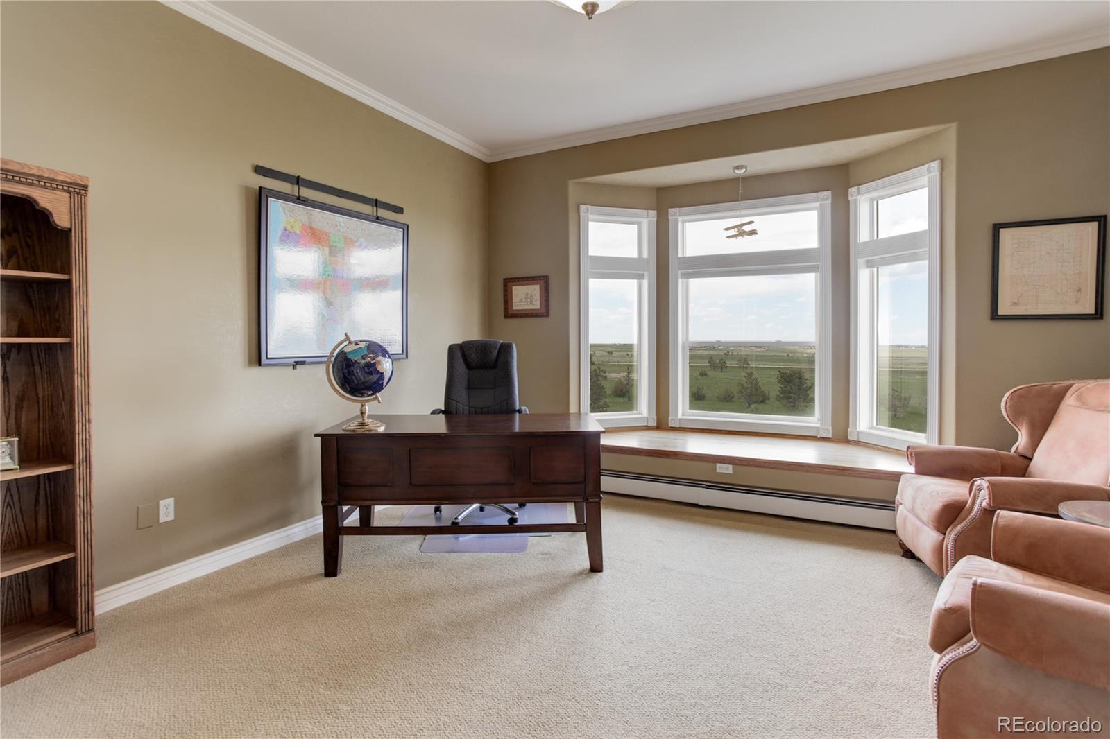 24943 Ben Kelly Road Elbert, CO 80106 - Photo 15 of 39 a view of a workspace with furniture and a window