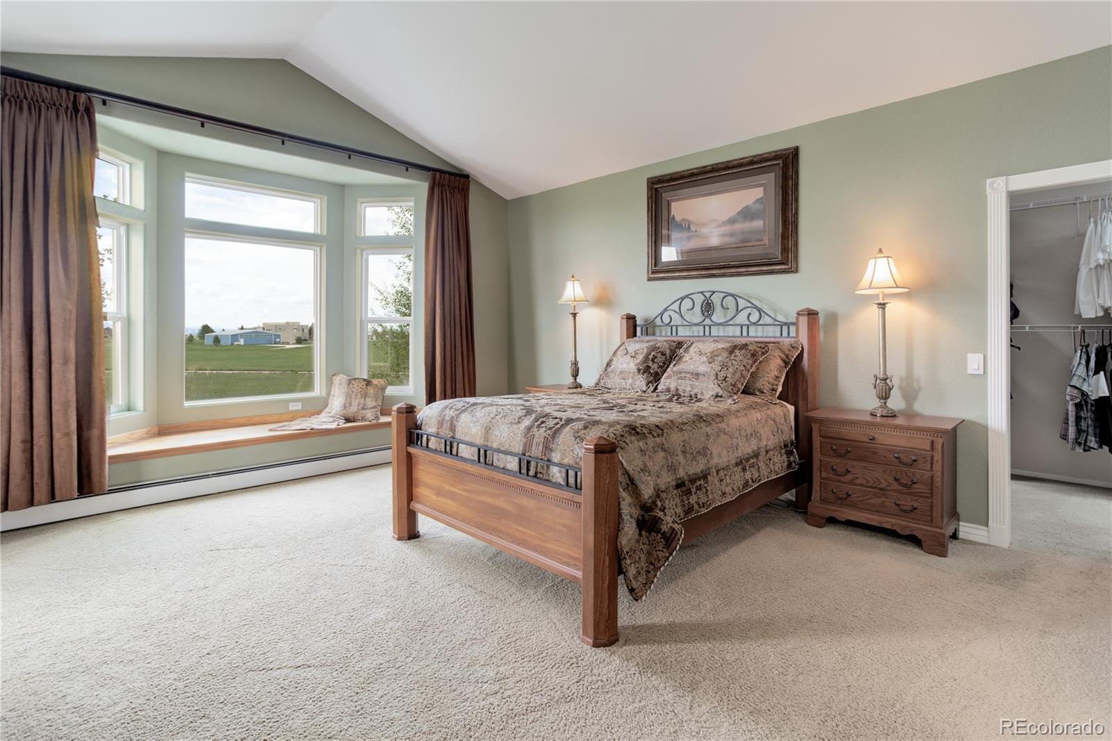 24943 Ben Kelly Road Elbert, CO 80106 - Photo 16 of 39 a bedroom with a large bed and a large window