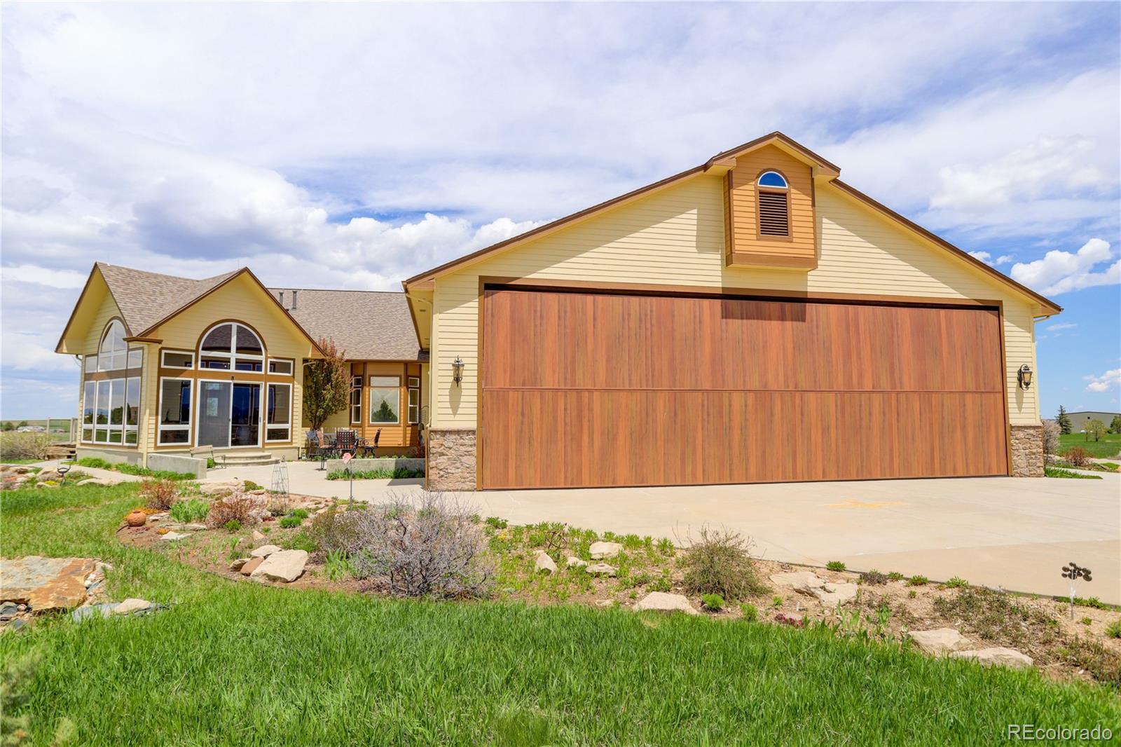 24943 Ben Kelly Road Elbert, CO 80106 - Photo 2 of 39 a front view of a house with garden