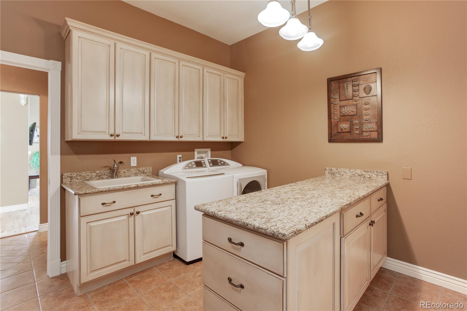 24943 Ben Kelly Road Elbert, CO 80106 - Photo 21 of 39 a utility room with a sink washer and dryer